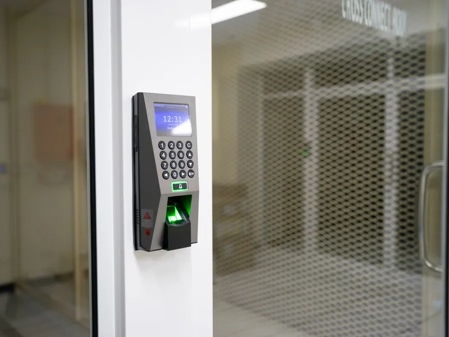 Electronic access reader beside a door in a commercial building
