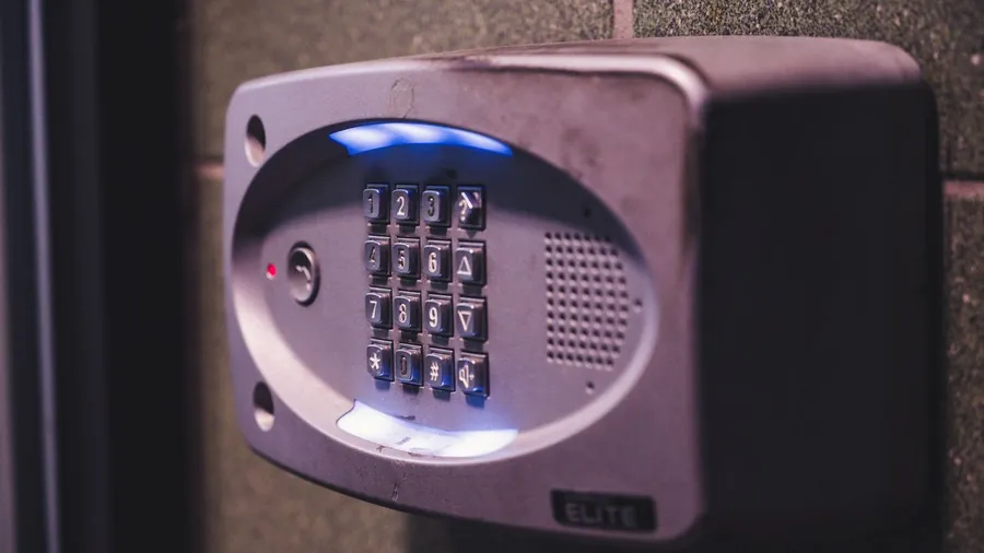 Illuminated alarm keypad mounted on a wall